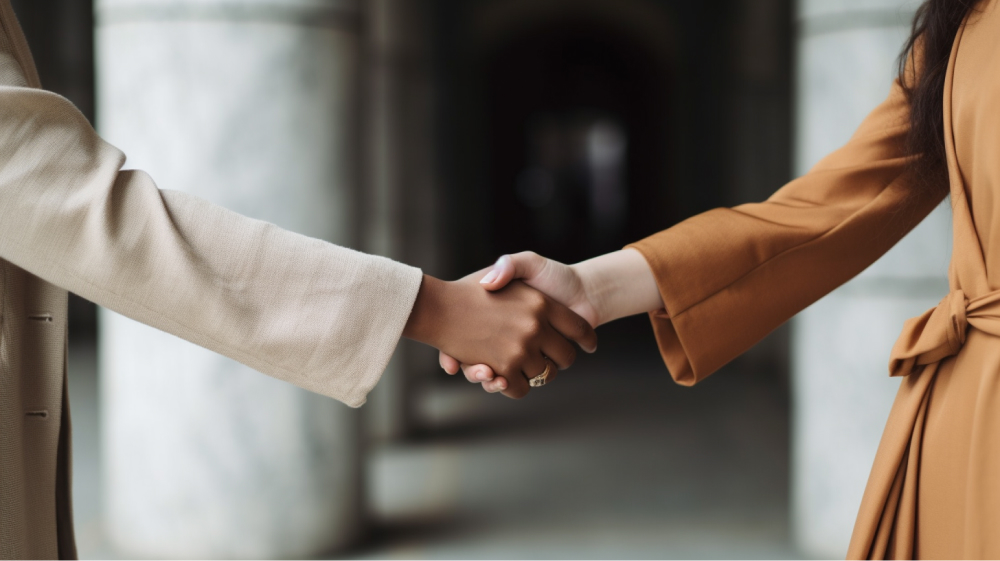 Handshake symbolizing successful negotiation in transitioning from a gifted collaboration to a paid collaboration.